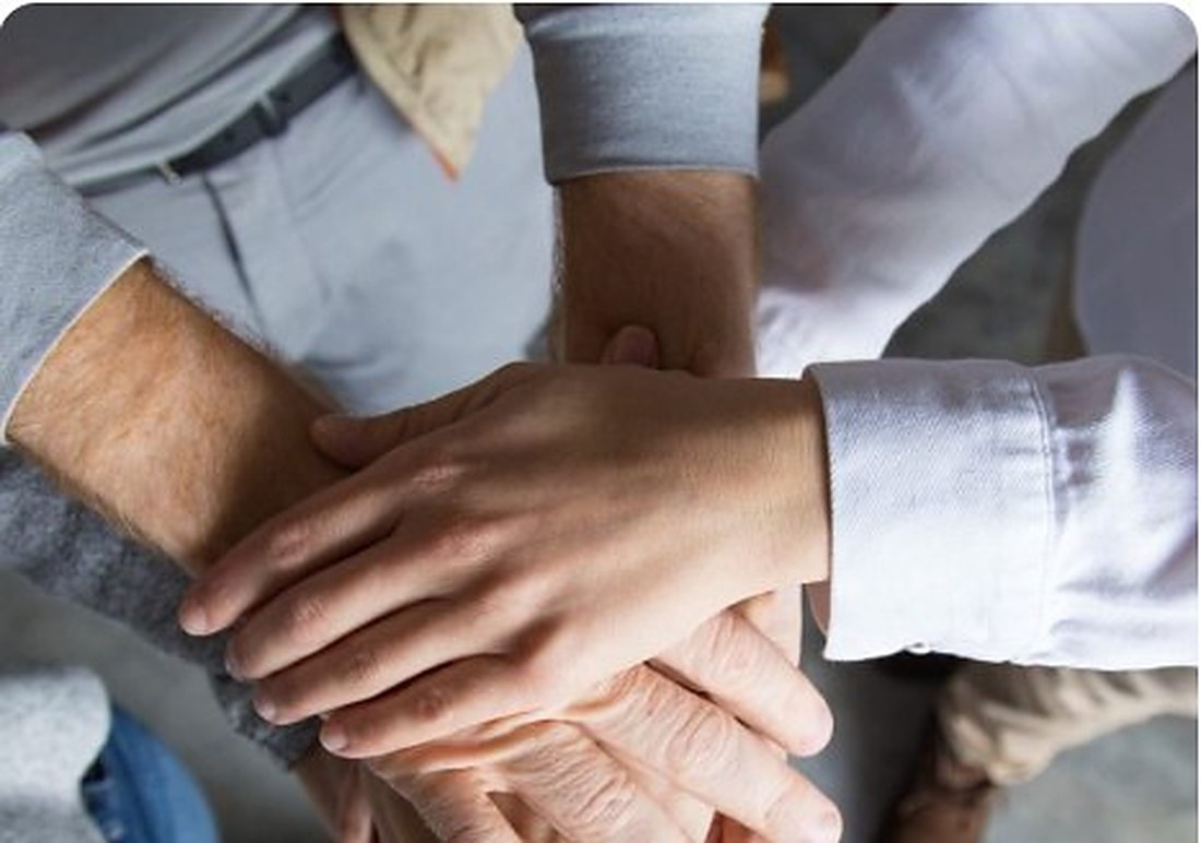 Team members' hands stacked together